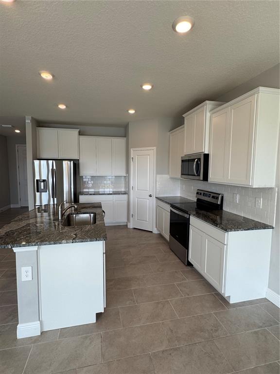 17710 Cantarina Cove Bradenton, FL 34211 - Photo 12 of 36 a kitchen with stainless steel appliances granite countertop a sink and a stove