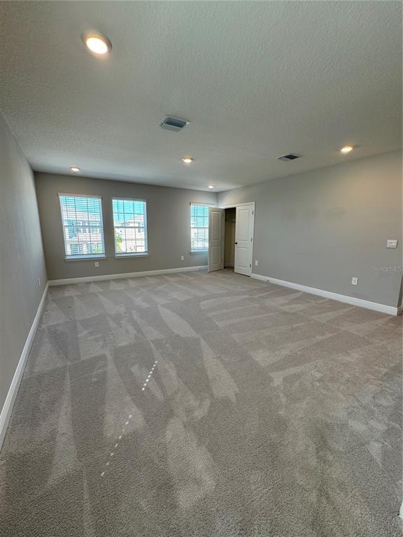 17710 Cantarina Cove Bradenton, FL 34211 - Photo 16 of 36 an empty room with windows and closet