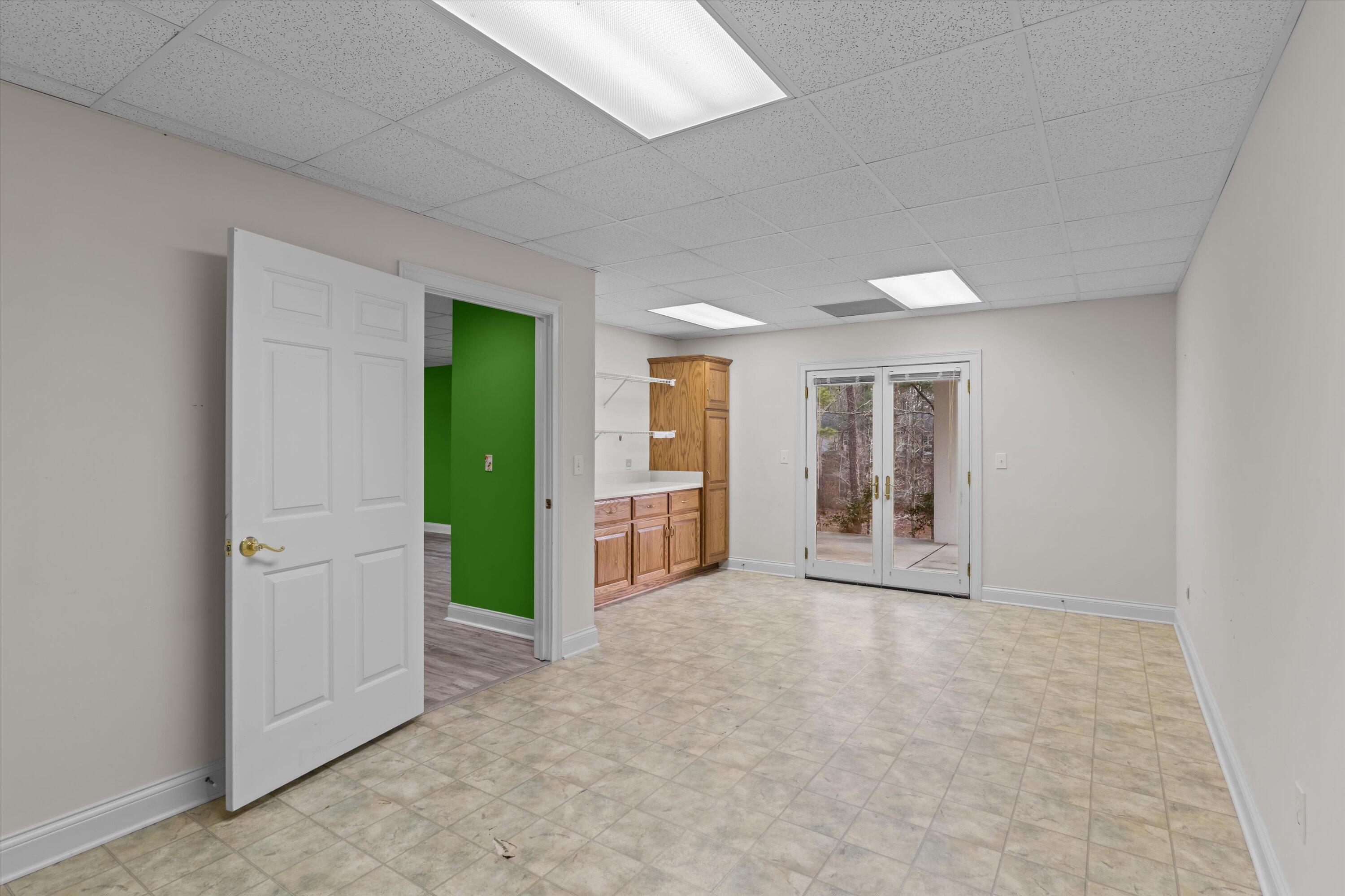 210 Daly Place McCormick, SC 29835 - Photo 42 of 58 Lower level bedroom 5 with cabinets and access to covered patio