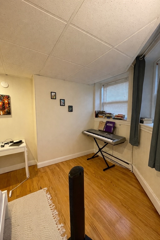 868 Beacon Street, Unit A Boston, MA 02215 - Photo 3 of 5 a workspace with furniture and wooden floor