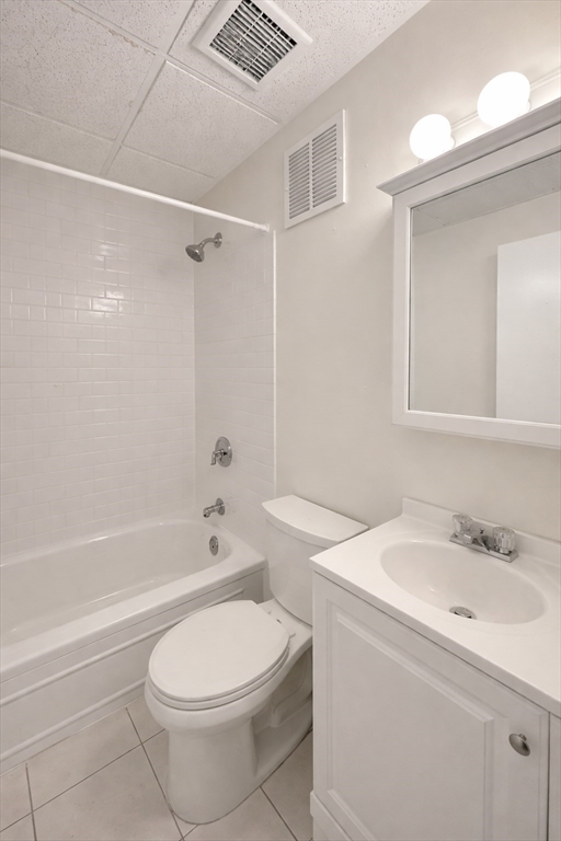 868 Beacon Street, Unit A Boston, MA 02215 - Photo 5 of 5 a bathroom with a toilet sink vanity tub and shower