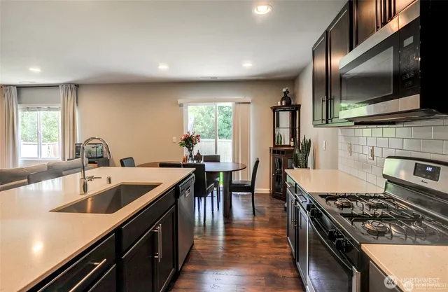a kitchen with sink stove and cabinets