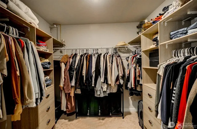 a view of walk in closet with clothes