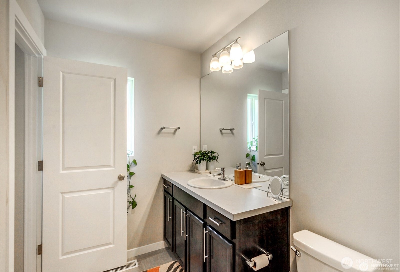 1326 11th Street Sultan, WA 98294 - Photo 28 of 31 a bathroom with a sink a light fixture and a mirror