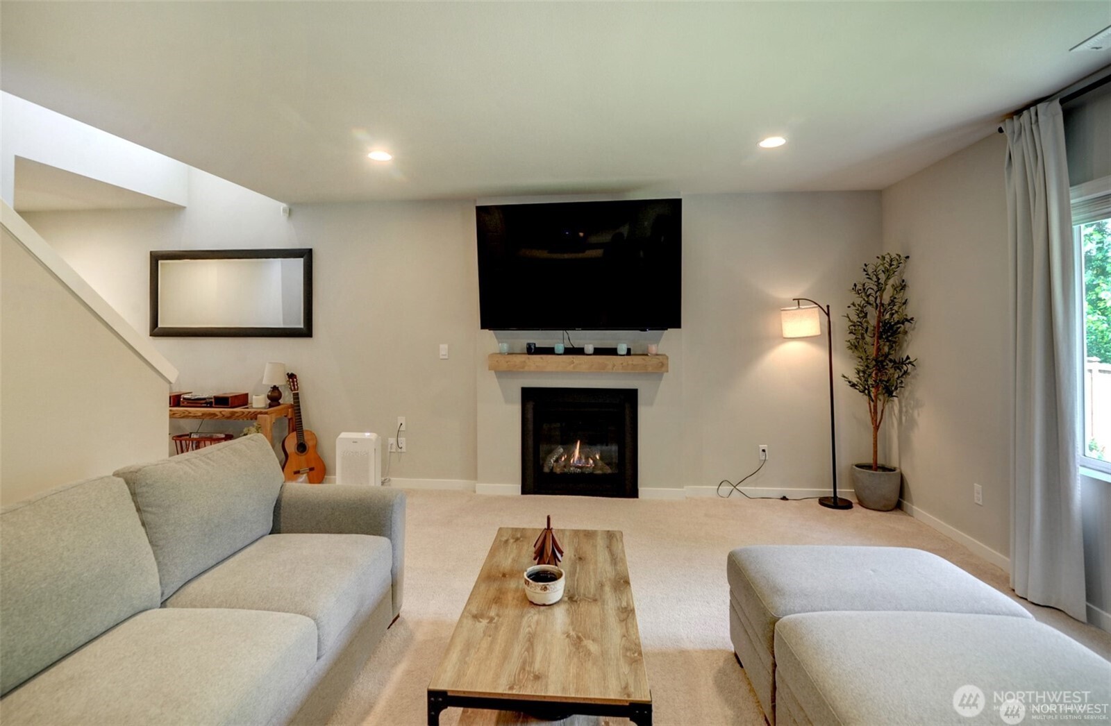 1326 11th Street Sultan, WA 98294 - Photo 5 of 31 a living room with furniture a flat screen tv and a fireplace