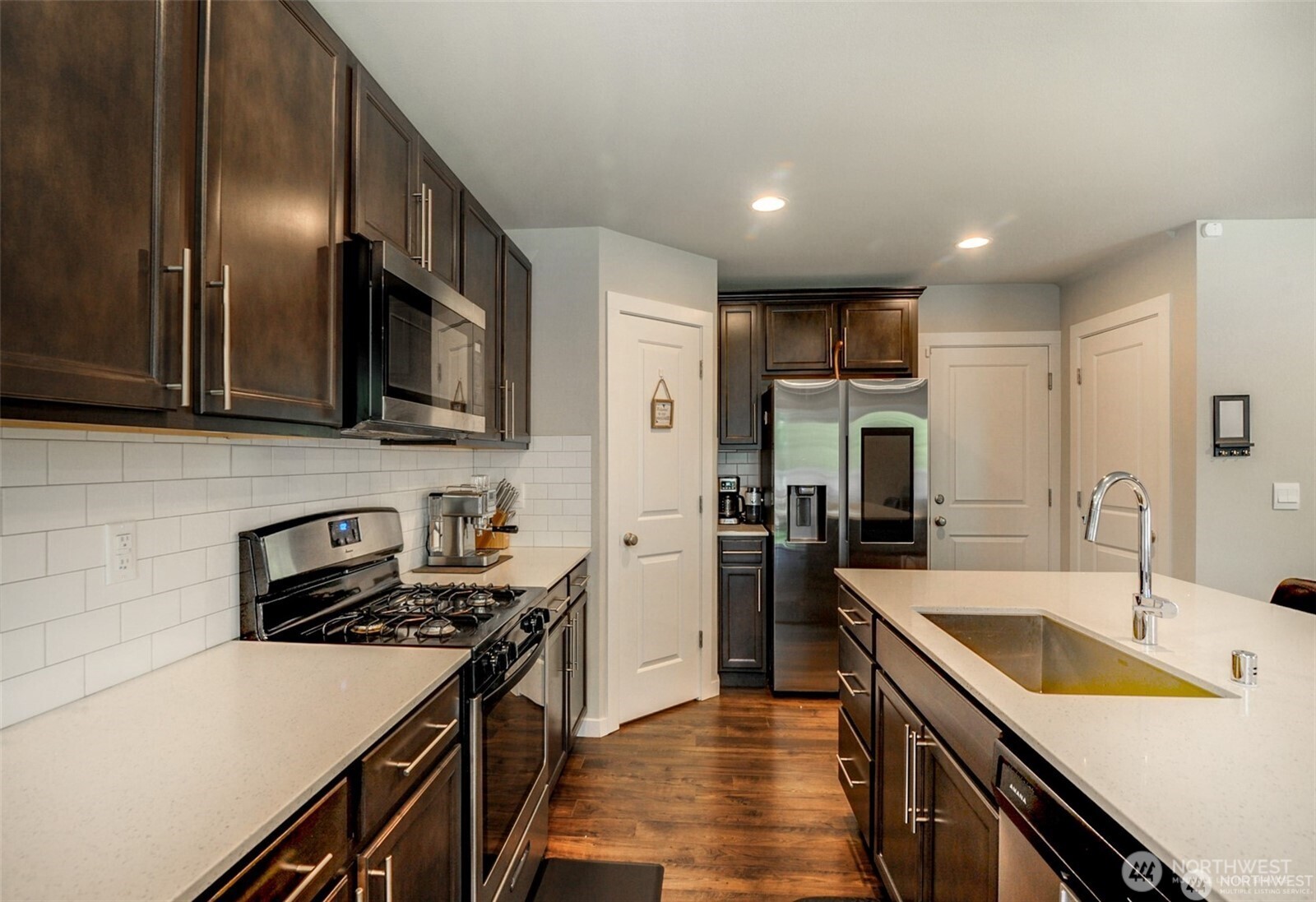 1326 11th Street Sultan, WA 98294 - Photo 8 of 31 a kitchen with a sink a stove and refrigerator