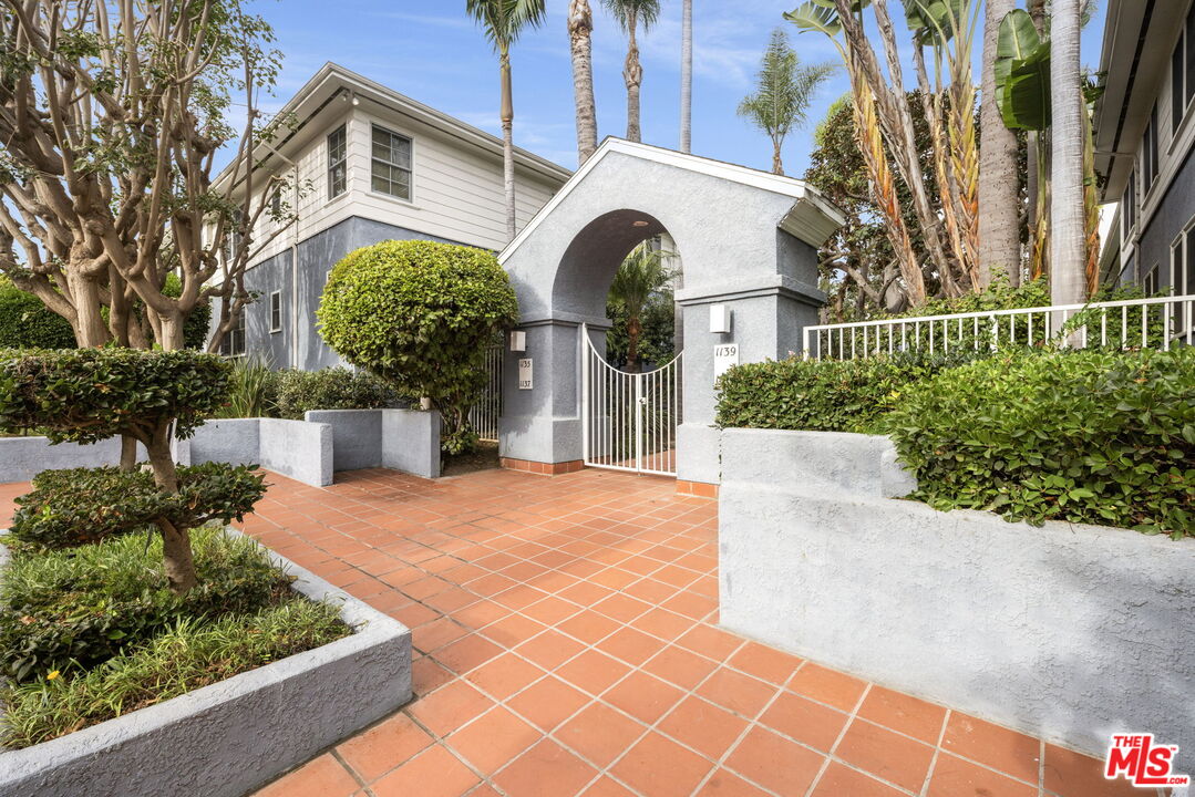 1137 26th Street, Unit D Santa Monica, CA 90403 - Photo 9 of 14 a front view of a house with a garden
