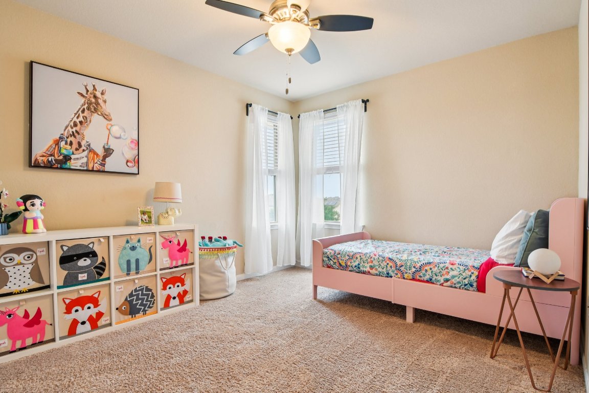 125 Checkerspot Court Georgetown, TX 78626 - Photo 24 of 40 a bedroom with baby toys and a chandelier