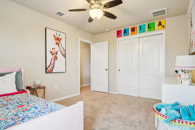 a very nice looking bedroom with a bed dresser and a couch