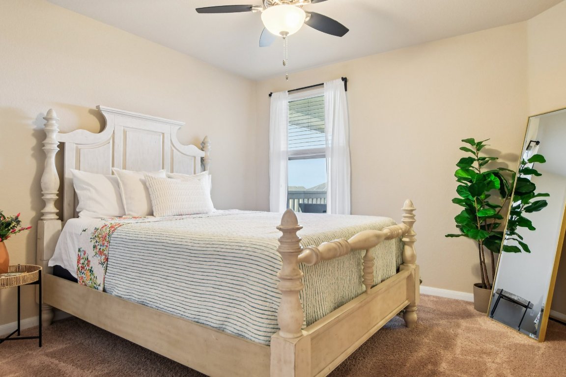 125 Checkerspot Court Georgetown, TX 78626 - Photo 29 of 40 a bedroom with bed and a potted plant