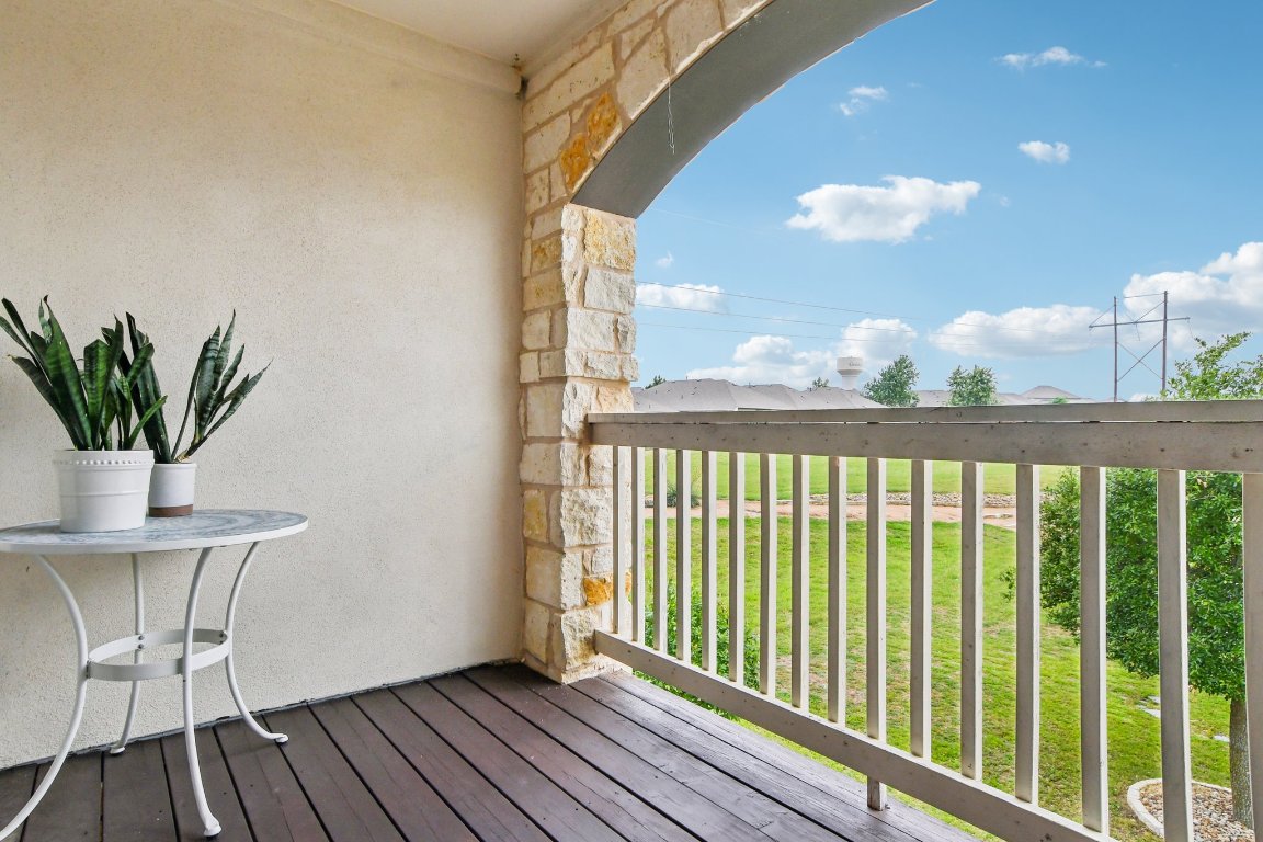 125 Checkerspot Court Georgetown, TX 78626 - Photo 32 of 40 a view of a balcony with wooden floor