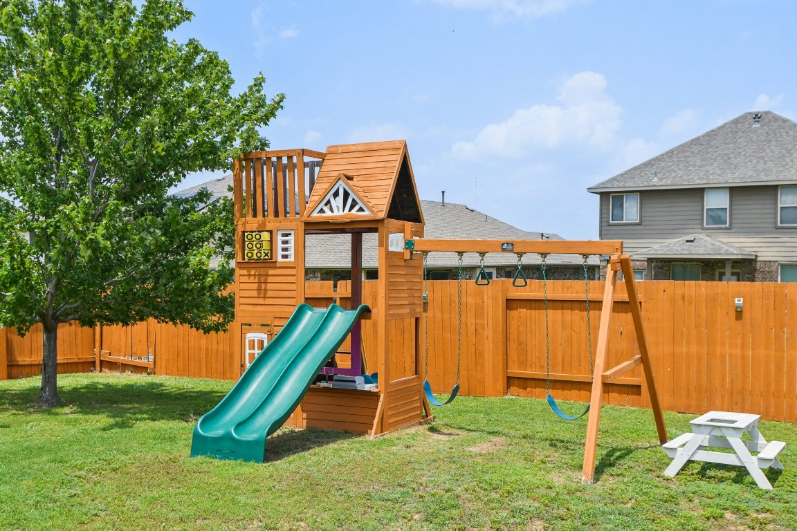 125 Checkerspot Court Georgetown, TX 78626 - Photo 33 of 40 a view of a house with a backyard and a slide