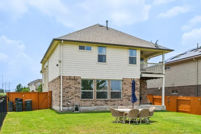 a view of a house with a yard and sitting area