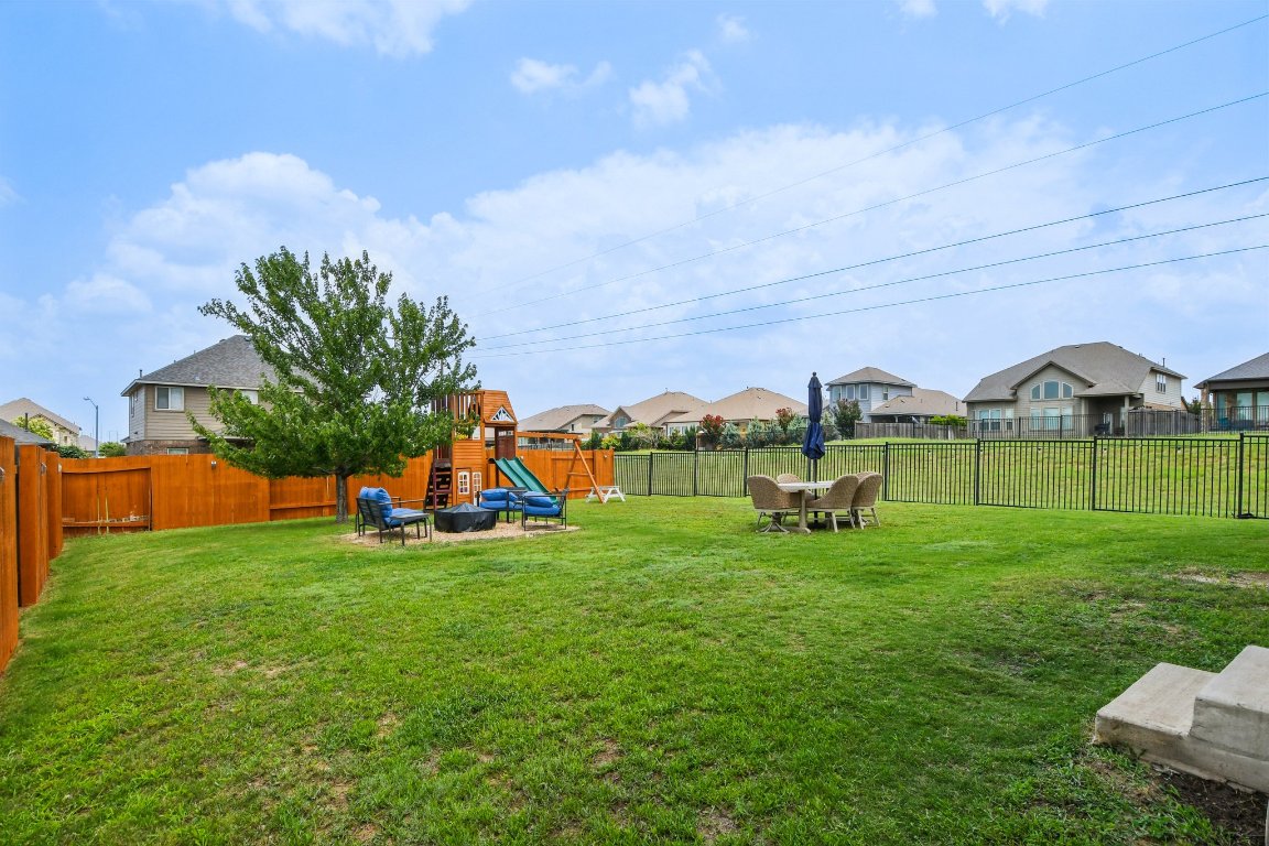 125 Checkerspot Court Georgetown, TX 78626 - Photo 36 of 40 a view of yard with swimming pool and green space