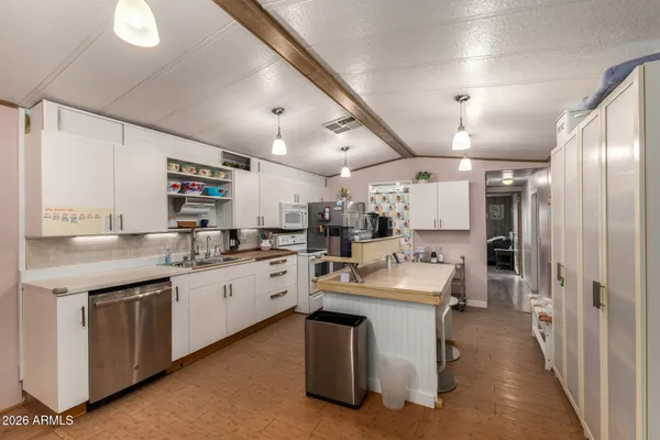 a kitchen with sink stove and refrigerator