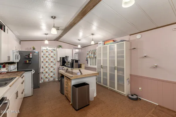 a kitchen with stainless steel appliances a stove a refrigerator and a stove