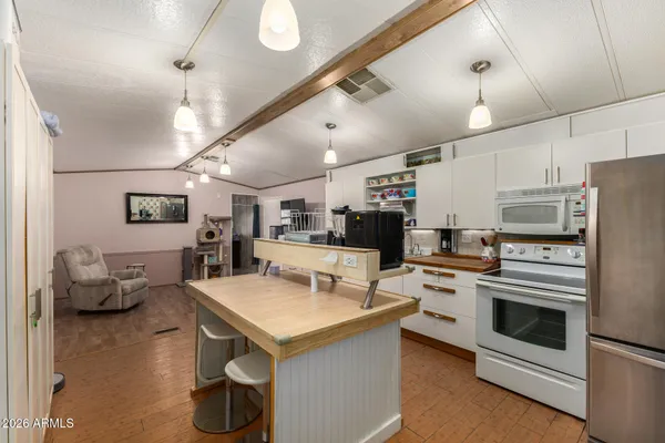 a kitchen with a sink stainless steel appliances and white cabinets