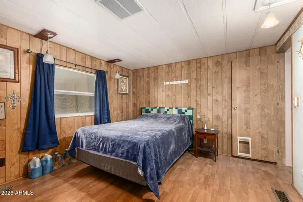 a bedroom with a bed and a window