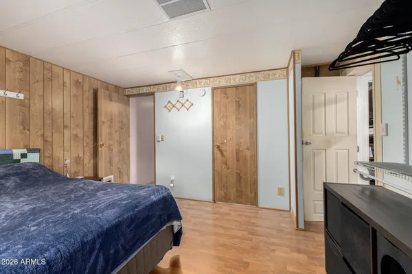 a bedroom with a large bed and a shower