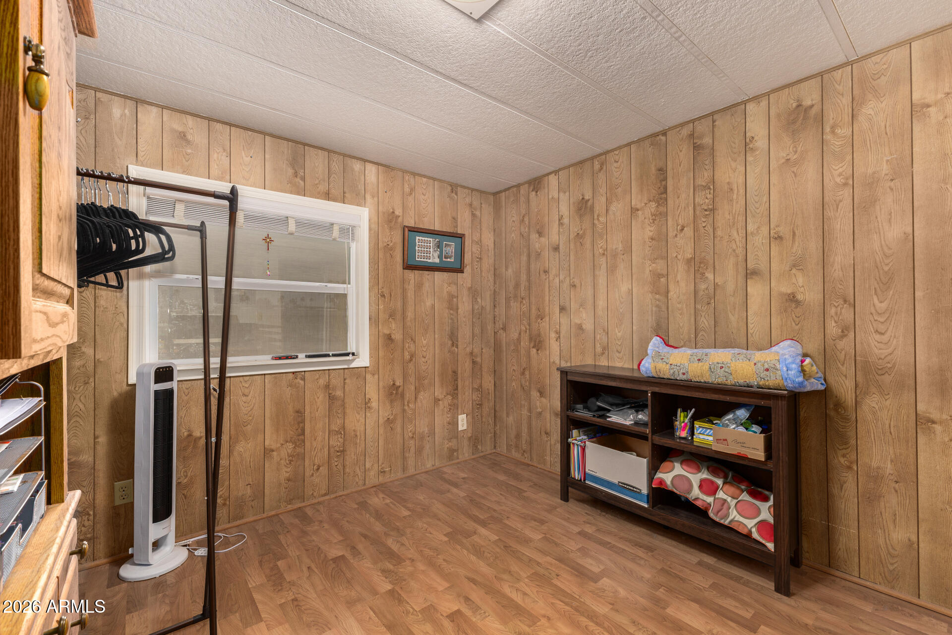834 South Meridian Road, Unit 144 Apache Junction, AZ 85120 - Photo 24 of 43 a view of an empty room with wooden floor and a window