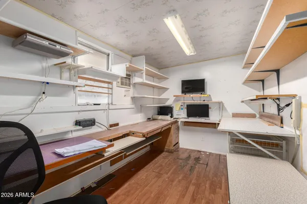 a kitchen with granite countertop a stove and a wooden floor