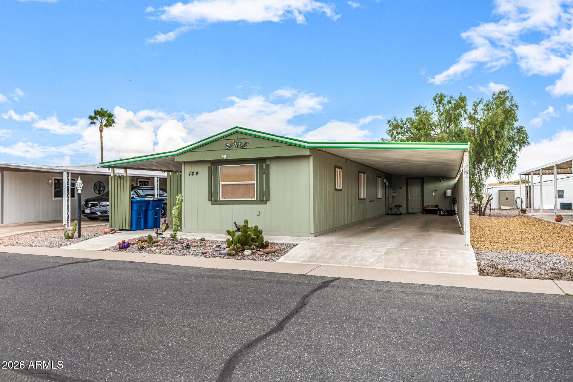 834 South Meridian Road, Unit 144 Apache Junction, AZ 85120 - Photo 3 of 43 a front view of a house with a yard