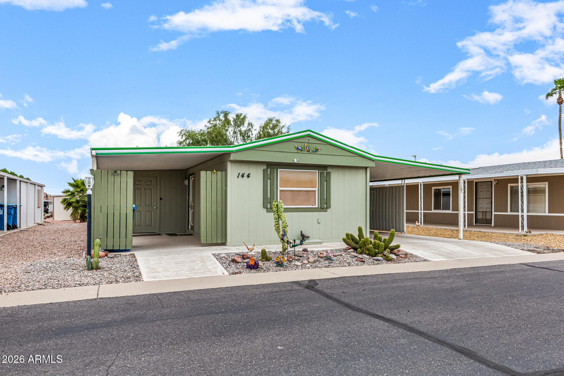 834 South Meridian Road, Unit 144 Apache Junction, AZ 85120 - Photo 5 of 43 a front view of a house with a yard