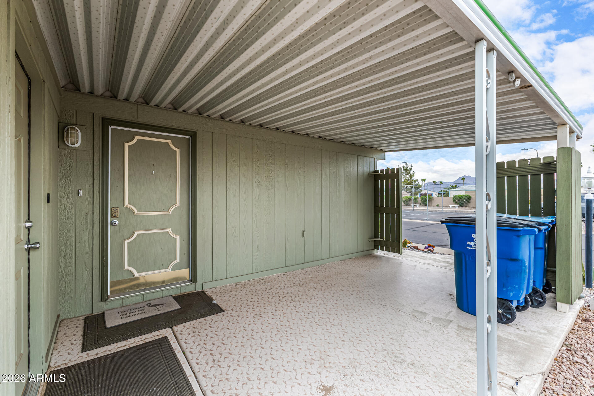 834 South Meridian Road, Unit 144 Apache Junction, AZ 85120 - Photo 7 of 43 a view of a porch with a table and chairs and floor to ceiling window