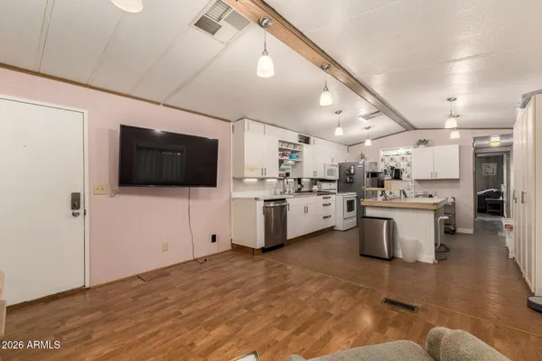 a view of a kitchen with microwave and cabinets