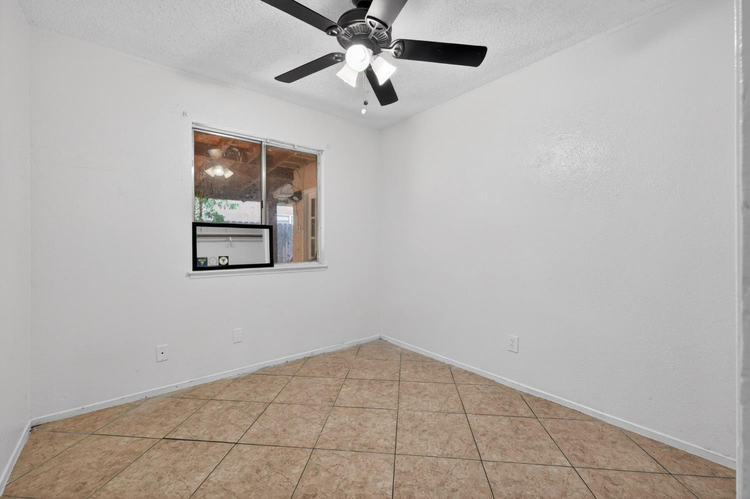 13591 East 5th Street Parlier, CA 93648 - Photo 19 of 31 a view of an empty room with a window