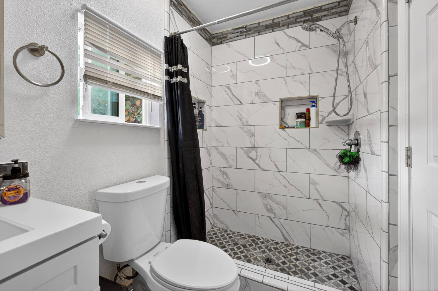 13591 East 5th Street Parlier, CA 93648 - Photo 21 of 31 a white toilet sitting next to a bathroom sink