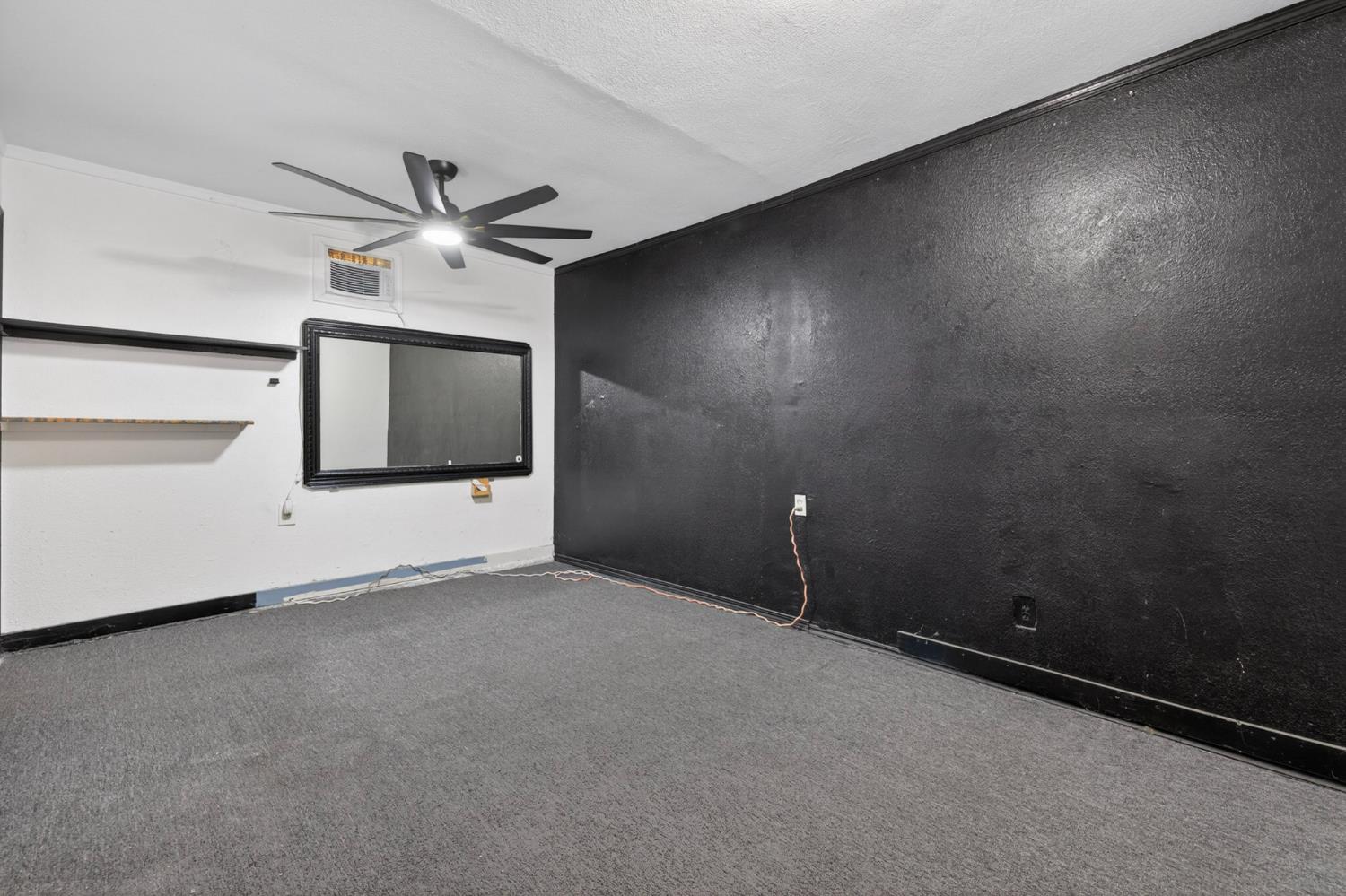 13591 East 5th Street Parlier, CA 93648 - Photo 24 of 31 an empty room with a ceiling fan and window