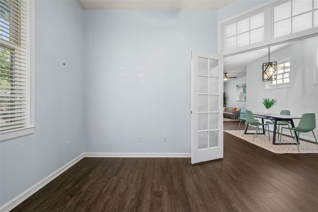 5213 Southwest 91 Terrace, Unit B Gainesville, FL 32608 - Photo 18 of 38 an empty room with wooden floor and windows