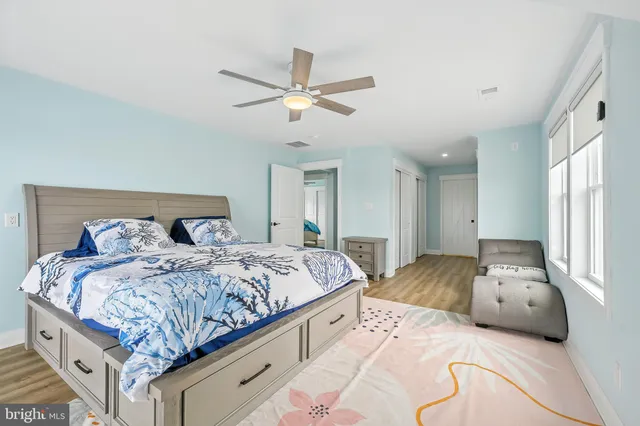 a bedroom with a large bed and a window