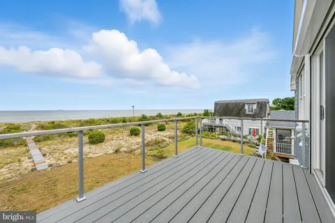 a living room with furniture and a view of kitchen