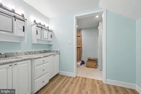 a kitchen with kitchen island a stove a refrigerator and a sink with granite countertops
