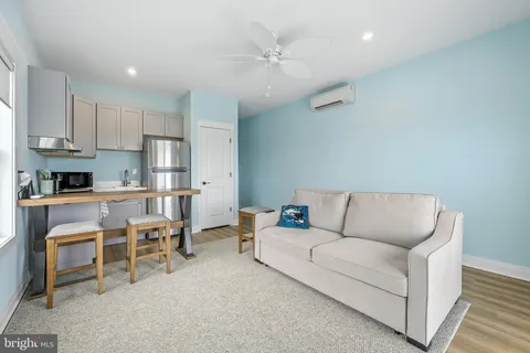 a bathroom with a toilet sink vanity and mirror