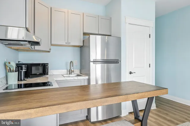a view of a city with flower plants and wooden fence
