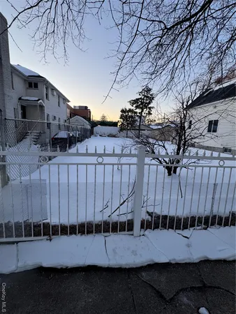 a view of a deck with furniture and wooden fence
