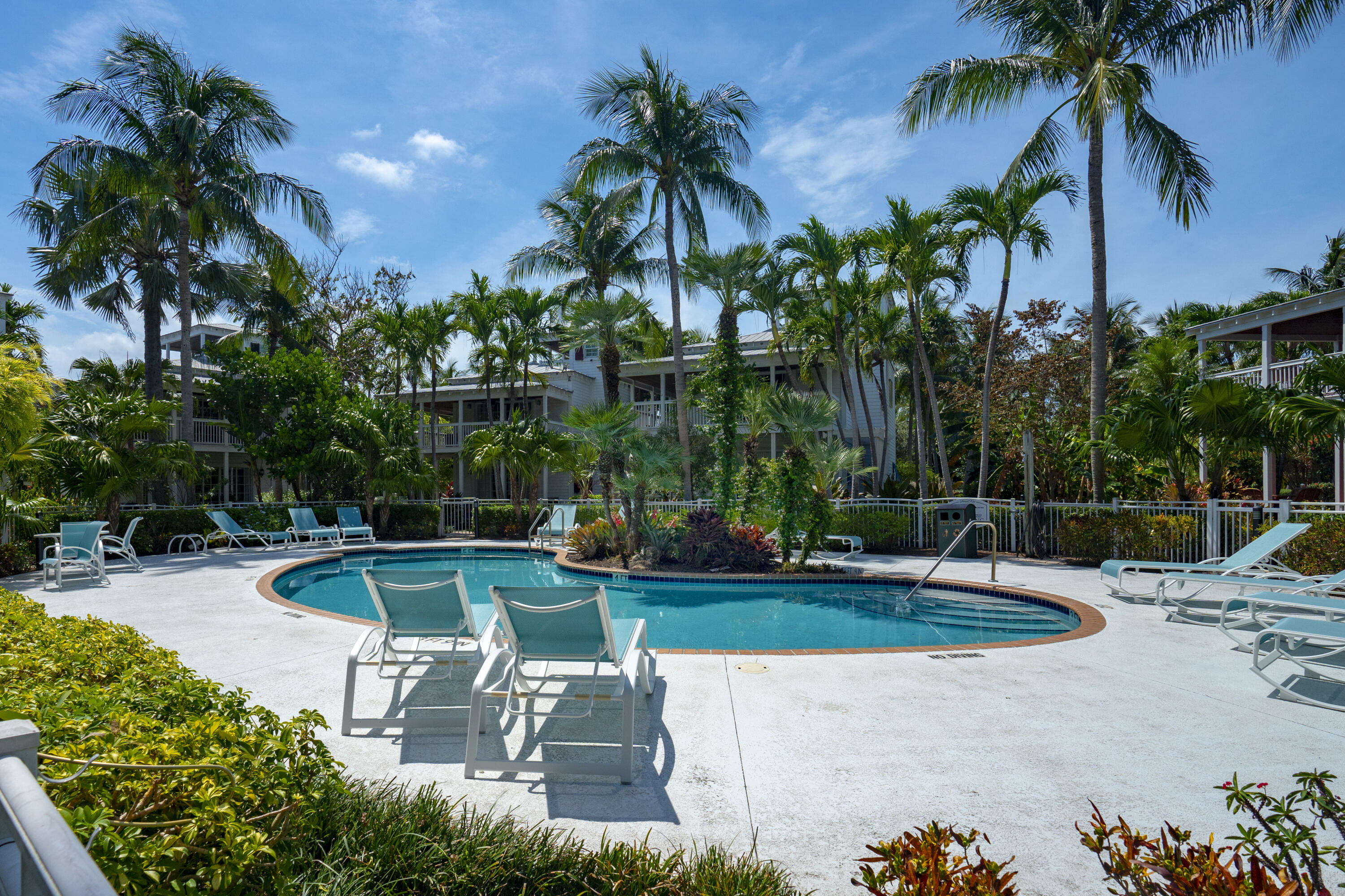 70 Sunset Key Drive Key West, FL 33040 - Photo 2 of 22 a view of a swimming pool with a patio and a garden