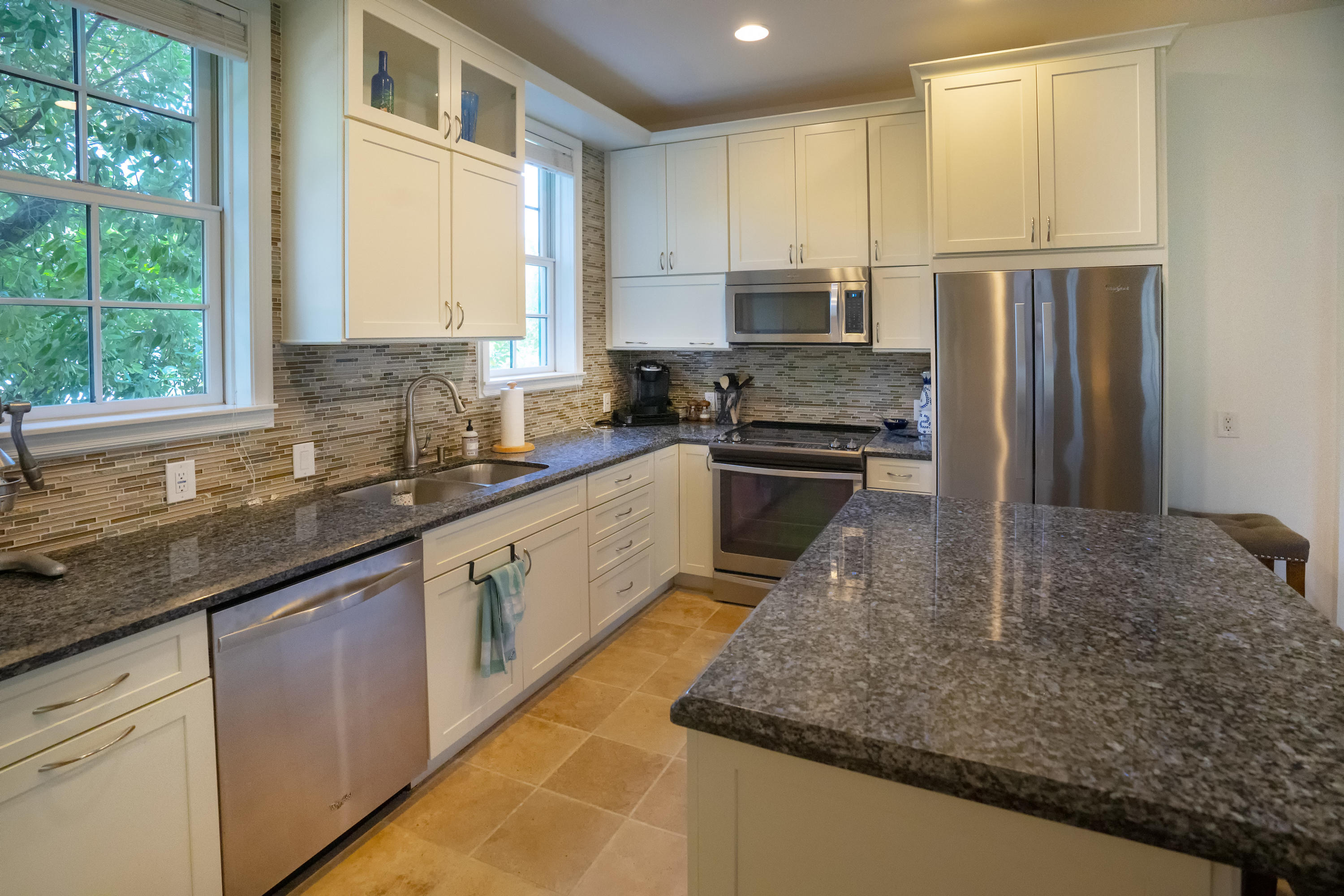 70 Sunset Key Drive Key West, FL 33040 - Photo 3 of 22 a kitchen with stainless steel appliances granite countertop a sink a stove and a refrigerator