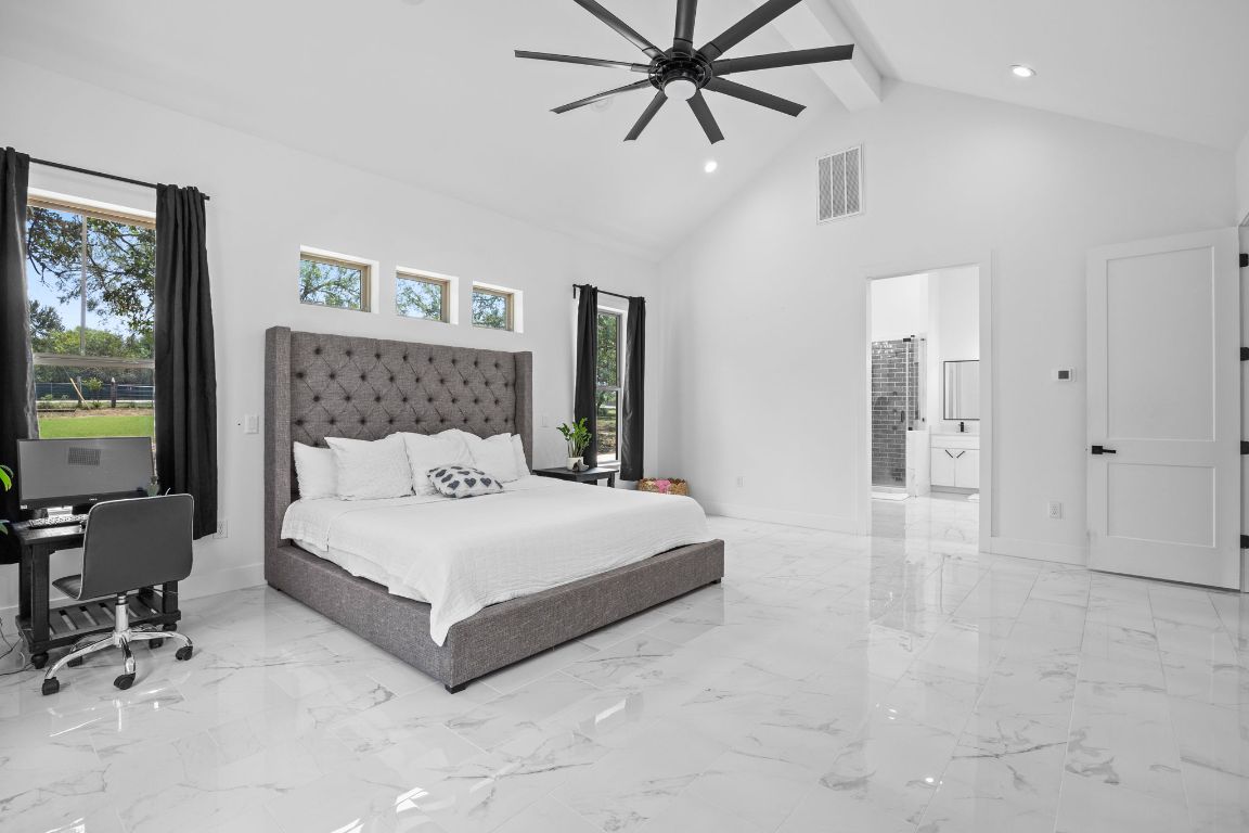 390 Riddle Road Cedar Creek, TX 78612 - Photo 14 of 27 a spacious bedroom with a bed and a table