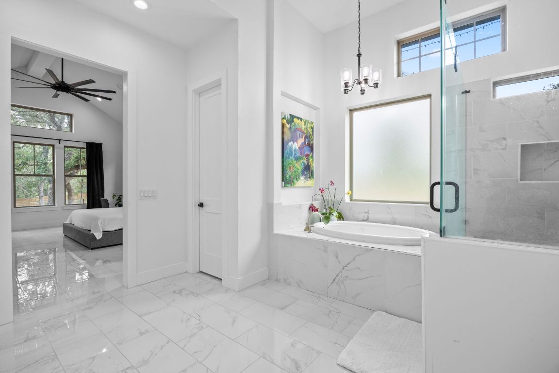 390 Riddle Road Cedar Creek, TX 78612 - Photo 16 of 27 a spacious bathroom with a tub sink and mirror