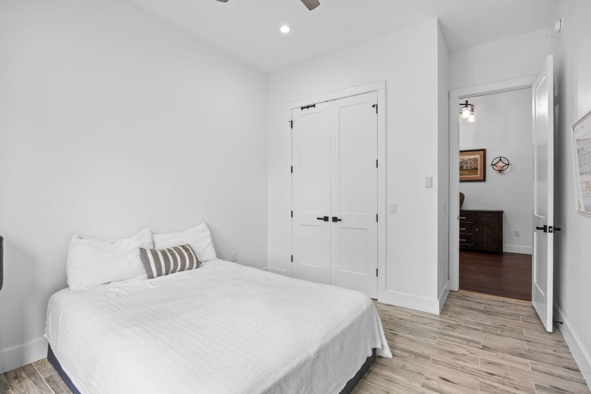 390 Riddle Road Cedar Creek, TX 78612 - Photo 21 of 27 a bedroom with a bed and a table