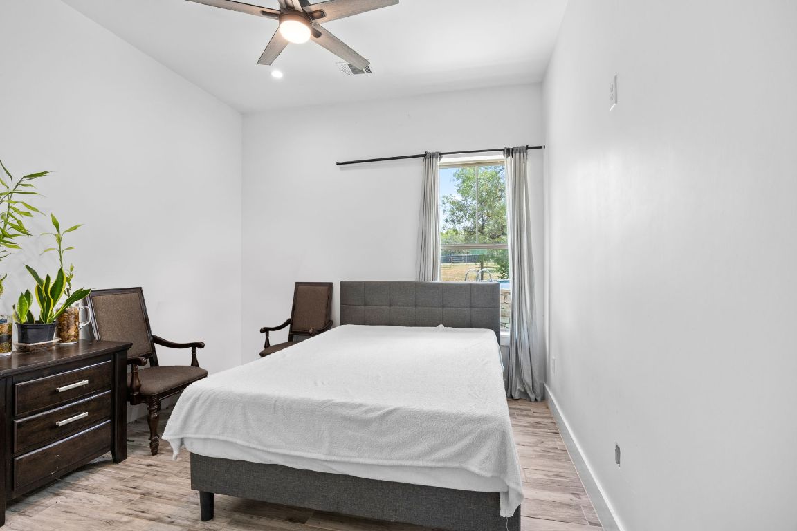 390 Riddle Road Cedar Creek, TX 78612 - Photo 23 of 27 a bedroom with a bed and window