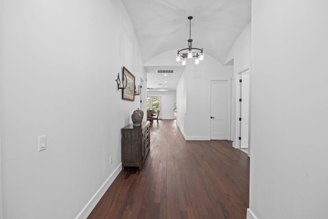 390 Riddle Road Cedar Creek, TX 78612 - Photo 5 of 27 a view of a room with a hardwood floor and a ceiling fan