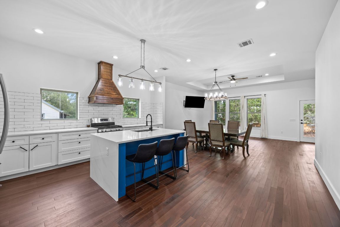 390 Riddle Road Cedar Creek, TX 78612 - Photo 6 of 27 a kitchen with stainless steel appliances granite countertop a stove and a wooden floors