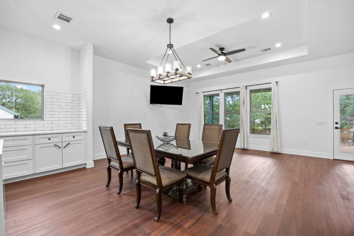 390 Riddle Road Cedar Creek, TX 78612 - Photo 10 of 27 a view of a dining room with furniture window and wooden floor