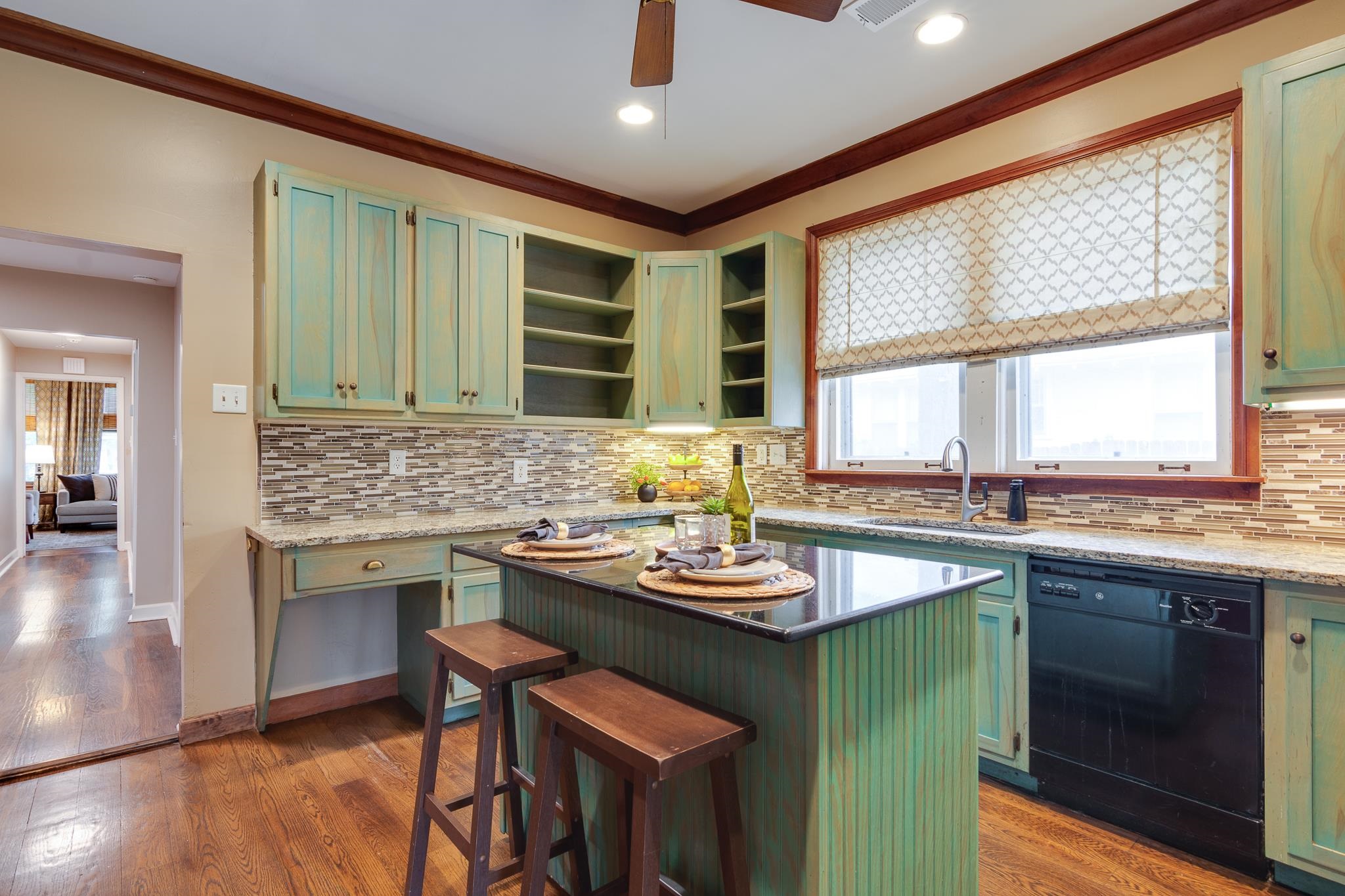 520 Ellsworth Street Memphis, TN 38111 - Photo 11 of 37 Kitchen featuring green cabinets, a kitchen island, black dishwasher, dark stone countertops, and ornamental molding
