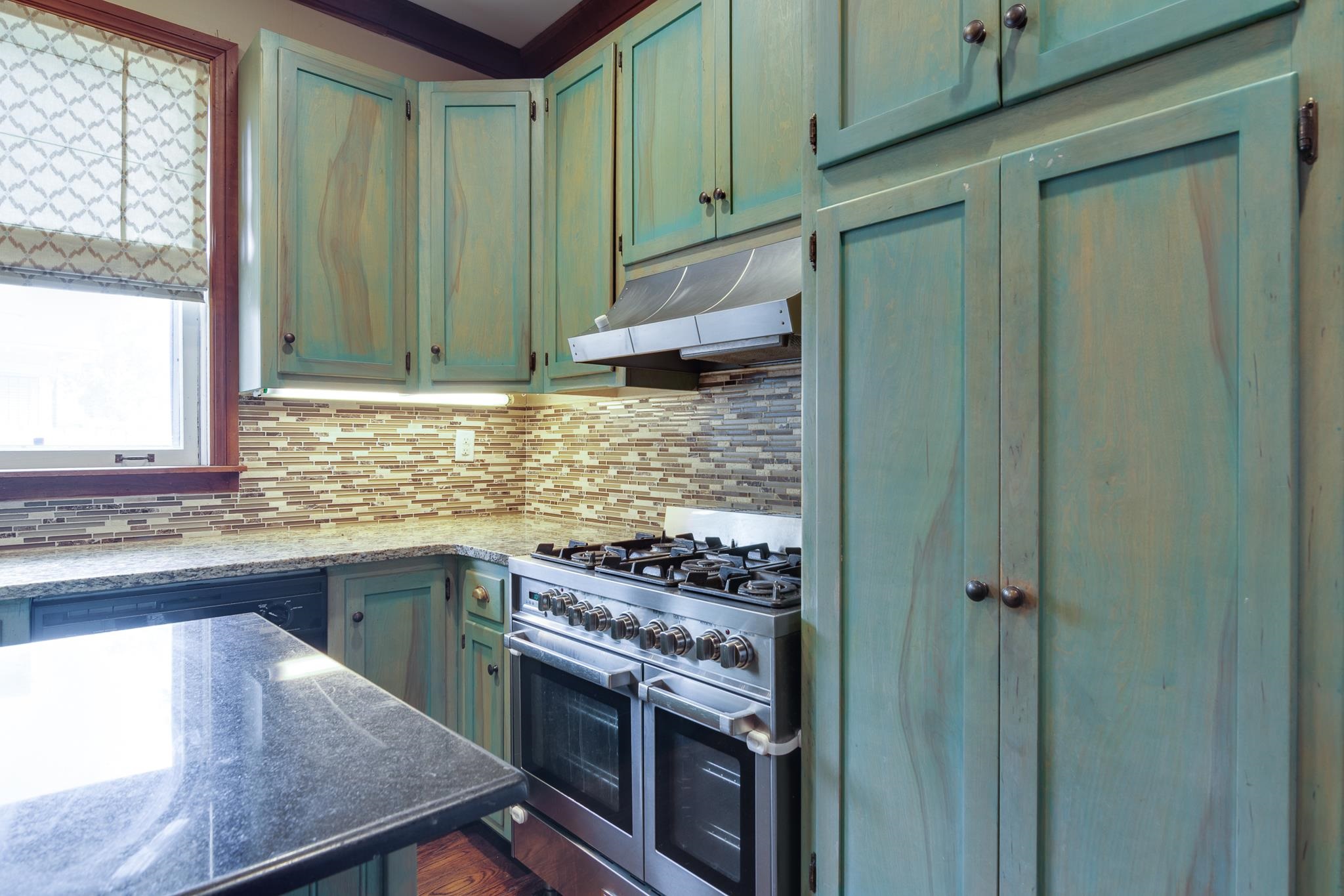 520 Ellsworth Street Memphis, TN 38111 - Photo 12 of 37 Kitchen featuring green cabinetry, dark stone counters, double oven range, and tasteful backsplash